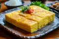 Traditional Japanese Omelette Tamagoyaki on a Ceramic Plate with Rice and Pickles Royalty Free Stock Photo