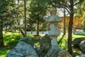 Traditional Japanese stone lamp, Snow Lantern by Yukimi Toro in Japanese garden of public landscape park of Krasnodar or Galitsky Royalty Free Stock Photo