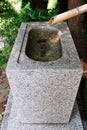 Traditional Japanese Stone Water Basin with Bamboo Pipe Royalty Free Stock Photo