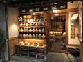 A Traditional Japanese Storefront Selling Senbei Rice Crackers on Display Jars