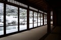 Traditional Japanese style formal room with view over snowy winter landscape from panorama windows