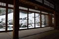 Traditional Japanese style room with a view over snowy winter landscape from panorama windows Royalty Free Stock Photo