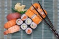 Traditional japanese sushi menu. Close-up of various kinds of sushi rolls with salmon, sashimi and other slices of raw fish and a Royalty Free Stock Photo