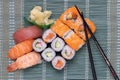 Traditional japanese sushi menu. Close-up of various kinds of sushi rolls with salmon, sashimi and other slices of raw fish and a Royalty Free Stock Photo