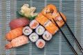 Traditional japanese sushi menu. Close-up of various kinds of sushi rolls with salmon, sashimi and other slices of raw fish and a Royalty Free Stock Photo