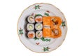 Traditional japanese sushi menu. Close-up of various kinds of sushi rolls with salmon, sashimi and other slices of raw fish served Royalty Free Stock Photo