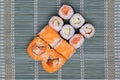 Traditional japanese sushi menu. Close-up of various kinds of sushi rolls with salmon, sashimi and other slices of raw fish served Royalty Free Stock Photo