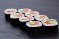 traditional Japanese sushi with salmon soft cheese avocado and red caviar garnished with creamy sauce. Japanese kitchen. Royalty Free Stock Photo