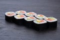 traditional Japanese sushi with salmon soft cheese avocado and red caviar garnished with creamy sauce. Japanese kitchen. Royalty Free Stock Photo