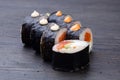 traditional Japanese sushi with salmon soft cheese avocado and red caviar garnished with creamy sauce. Japanese kitchen. Royalty Free Stock Photo