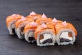 traditional Japanese sushi with salmon soft cheese avocado and red caviar garnished with creamy sauce. Japanese kitchen. Royalty Free Stock Photo