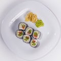 Traditional Japanese sushi with shrimp, salmon, soft cheese, cucumber and red caviar, decorated with creamy sauce. Japanese Royalty Free Stock Photo