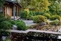 Traditional Japanese tea house with pond, wooden bridge, garden with stones and green bushes Royalty Free Stock Photo