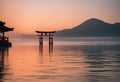 Traditional Japanese Tori gate standing in the water illuminated by the rising sun, AI-generated.