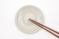 Traditional Japanese wooden chopstick on white ceramic plate.