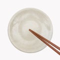 Traditional Japanese wooden chopstick on white ceramic plate