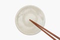 Traditional Japanese wooden chopstick on white ceramic plate