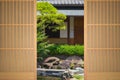 traditional Japanese wooden door opens to a Japanese garden Royalty Free Stock Photo