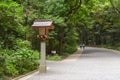 Traditional Japanese wooden lantern on pathway in Meiji-Jingu Shrine, Japan Royalty Free Stock Photo