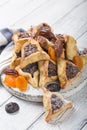 Traditional Jewish Hamantaschen cookies with dried apricots, dates. Purim celebration concept. ÃÂ¡arnival holiday background.