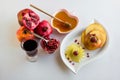 Traditional Jewish Holiday Rosh Hashanah with symbolic foods pomegranate, juice, apple on white