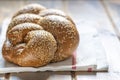 Traditional Jewish sweet Challah bread for Shabbat on a white textile on a wooden table  . Royalty Free Stock Photo