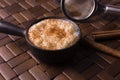 Traditional June party Brazilian dessert made of rice and condensed milk called arroz doce decorated with cinnamon in wood
