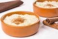 Traditional June party Brazilian dessert made of rice and condensed milk called arroz doce in white background close