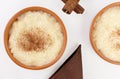 Traditional June party Brazilian dessert made of rice and condensed milk called arroz doce in white background seen from above