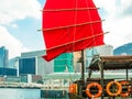 Traditional junk sailboat with red sails in the Victoria harbor, Hong Kong Royalty Free Stock Photo
