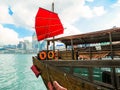 Traditional junk sailboat with red sails in the Victoria harbor, Hong Kong Royalty Free Stock Photo