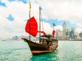 Traditional junk sailboat with red sails in the Victoria harbor, Hong Kong Royalty Free Stock Photo