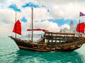 Traditional junk sailboat with red sails in the Victoria harbor, Hong Kong Royalty Free Stock Photo