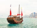 Traditional junk sailboat with red sails in the Victoria harbor, Hong Kong Royalty Free Stock Photo