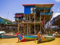 Traditional Kampong Phluk floating village with multicolored boats and stilt houses, Tonle Sap lake, Siem Reap Province, Cambodia Royalty Free Stock Photo