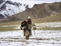 Traditional Kazakh eagle hunter with his golden eagle against th