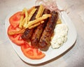 Traditional Kebab plate, with meat steaks, fries tomato and tzatziki Royalty Free Stock Photo