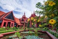 Traditional Khmer architecture and beautiful courtyard of the National Museum of Cambodia, lush pond with lotus, colorful flowers Royalty Free Stock Photo