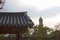 Traditional korean Buildings and trees with a catholic christan church on one picture.