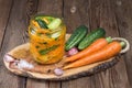 Traditional Korean snack of cucumbers in a glass jar: cucumbers marinated with carrots, hot pepper and garlic, with vegetable oil. Royalty Free Stock Photo