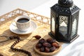 Traditional lantern, dates, coffee, and rosary on straw mat Royalty Free Stock Photo
