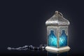 Traditional lantern with rosary beads on a dark background