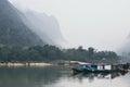 Traditional Laotian wooden slow boat on Nam Ou river near Nong Khiaw village, Laos Royalty Free Stock Photo