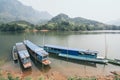 Traditional Laotian wooden slow boat on Nam Ou river near Nong Khiaw village, Laos Royalty Free Stock Photo
