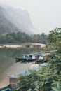 Traditional Laotian wooden slow boat on Nam Ou river near Nong Khiaw village, Laos Royalty Free Stock Photo