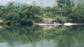 Traditional Laotian wooden slow boat on Nam Ou river near Nong Khiaw village, Laos Royalty Free Stock Photo