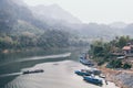 Traditional Laotian wooden slow boat on Nam Ou river near Nong Khiaw village, Laos Royalty Free Stock Photo