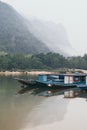 Traditional Laotian wooden slow boat on Nam Ou river near Nong Khiaw village, Laos Royalty Free Stock Photo