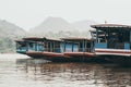 Traditional Laotian wooden slow boats on Mekong river near Luang Prabang, Laos