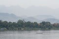 Traditional Laotian wooden slow boats on Mekong river near Luang Prabang, Laos